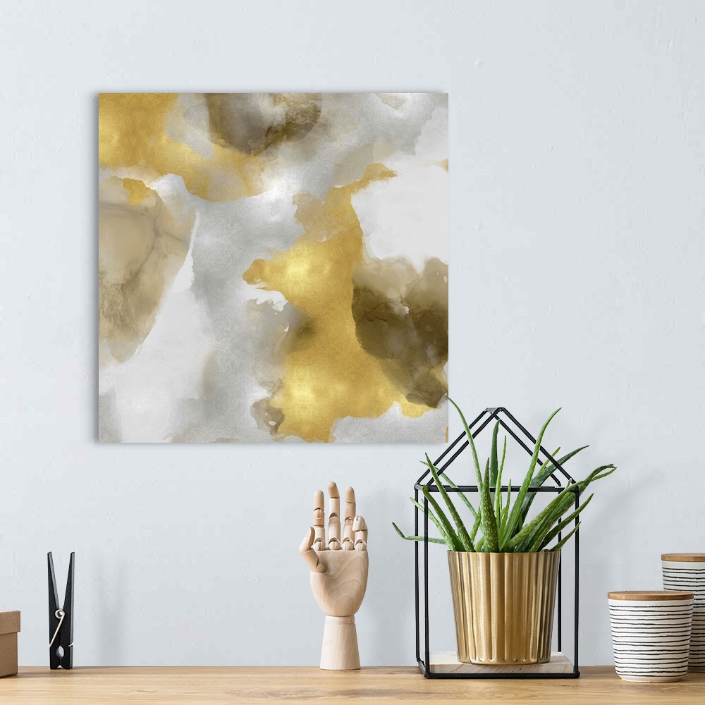 A bohemian room featuring Abstract painting with metallic gold and silvers splattered together on a gray background.