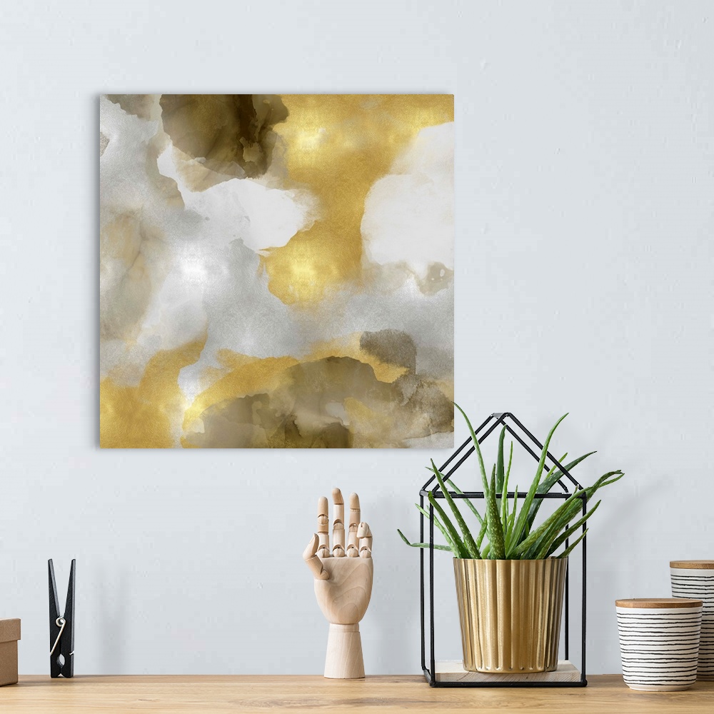 A bohemian room featuring Abstract painting with metallic gold and silvers splattered together on a gray background.
