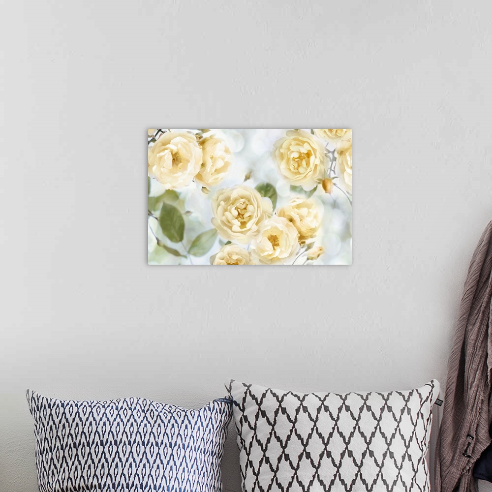 A bohemian room featuring Decorative artwork featuring soft yellow flowers over a bokeh background.