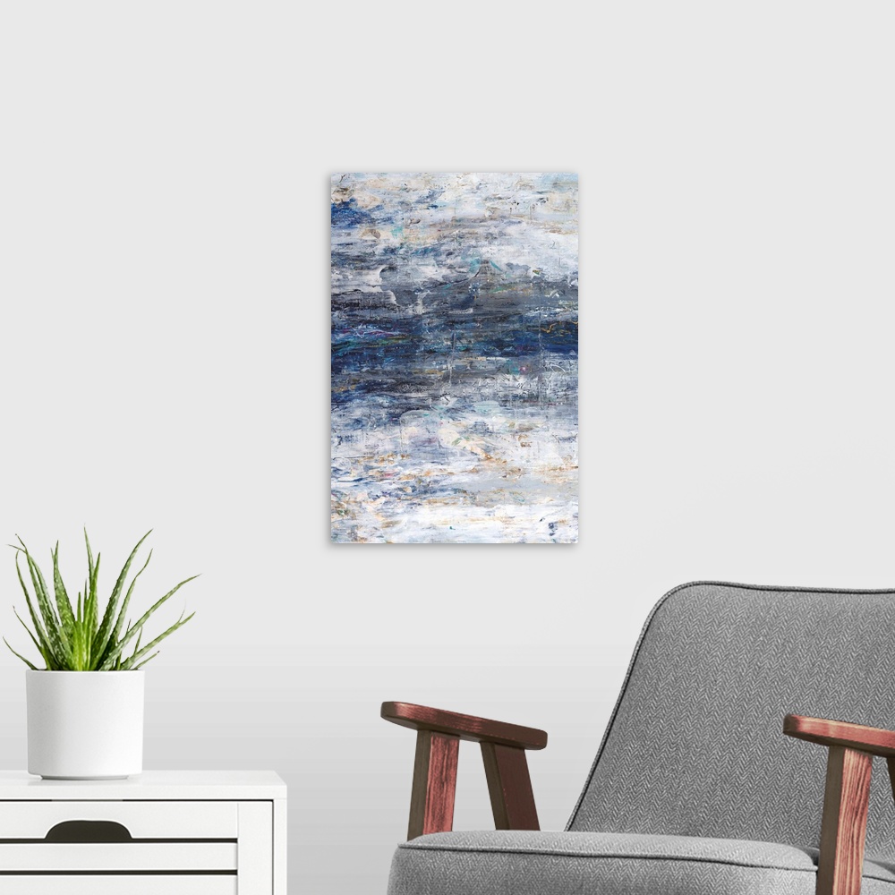 A modern room featuring Vertical abstract painting in textured colors of blue, white, brown and gray.