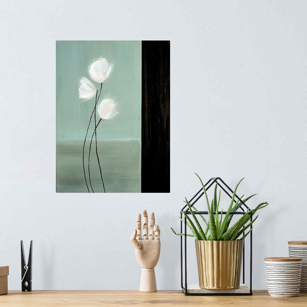 A bohemian room featuring Vertical painting of three white flowers with long stems against a teal background with a black b...