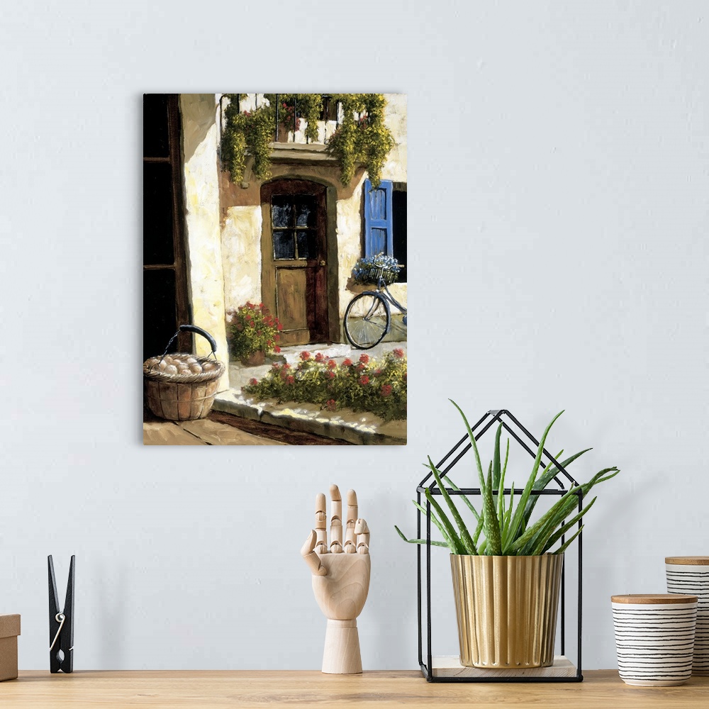 A bohemian room featuring Painting of a bicycle near a door in a European village.