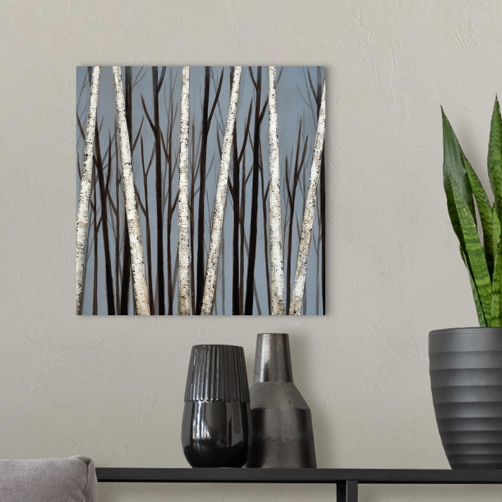 A modern room featuring A square painting of a forest of birch trees with shadows of darker trees in the background.