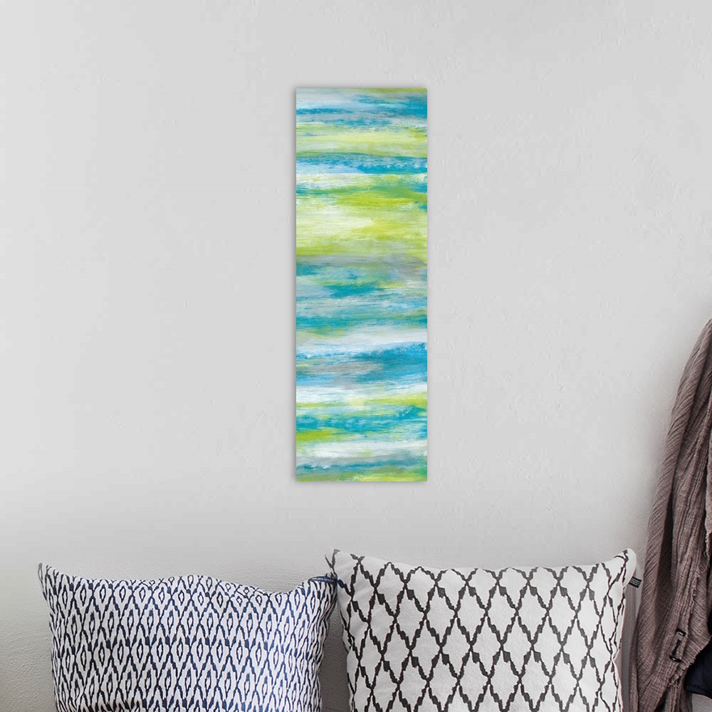 A bohemian room featuring A long abstract painting of bright textured colors in blue, gray and green.