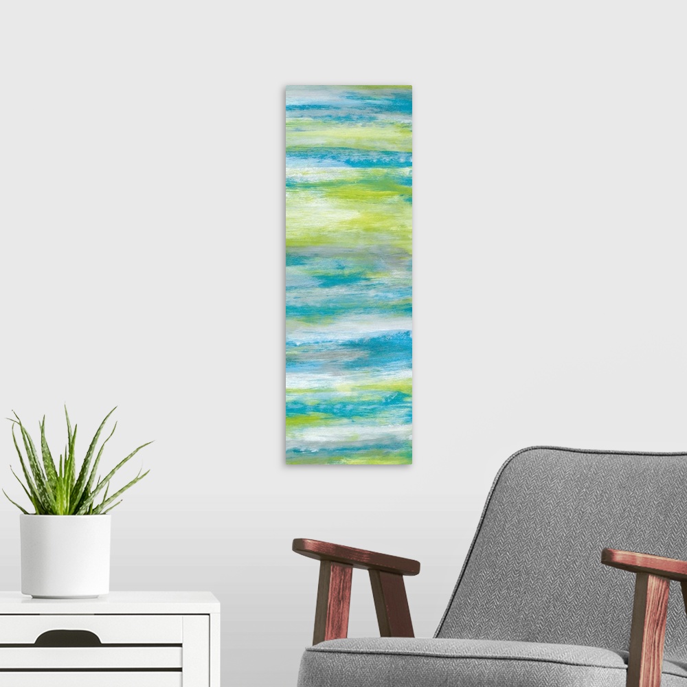 A modern room featuring A long abstract painting of bright textured colors in blue, gray and green.