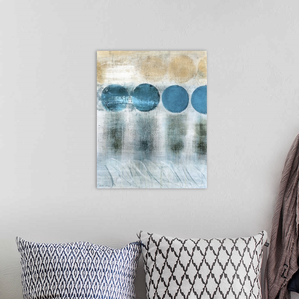 A bohemian room featuring A vertical abstract painting in blue and brown tones with circles and textured strokes.