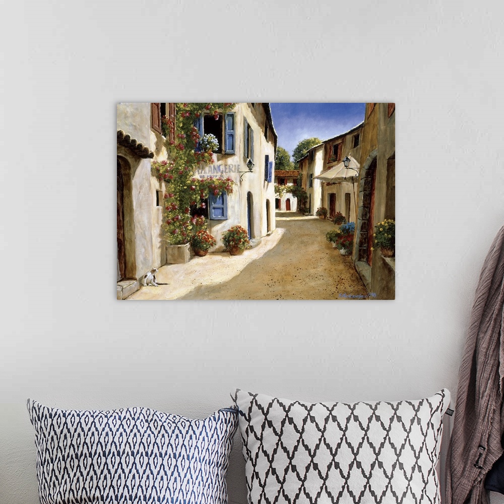 A bohemian room featuring Painting of a quiet alleyway in a European village.