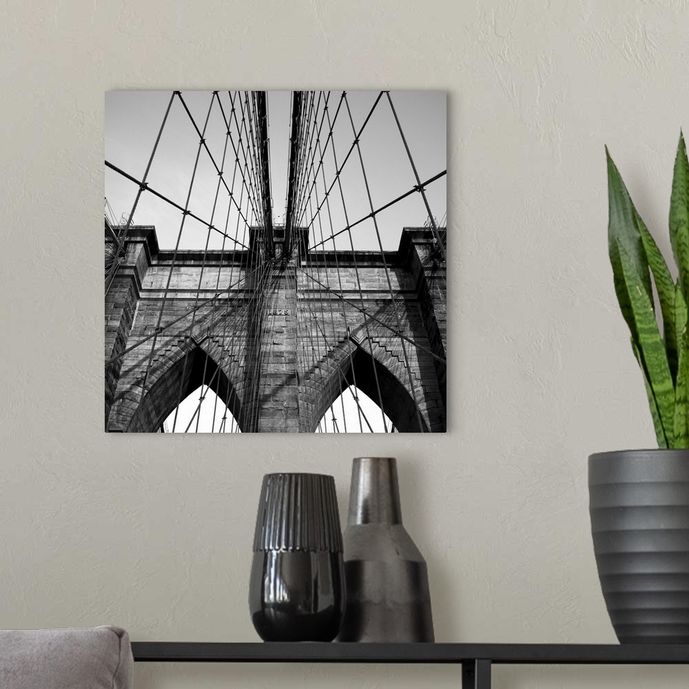 A modern room featuring Black and white close up of the Brooklyn Bridge.