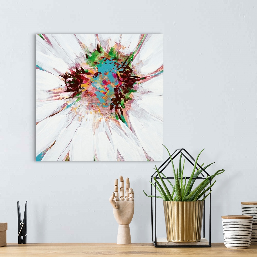 A bohemian room featuring A square painting of close up center of a daisy in multiple colors.