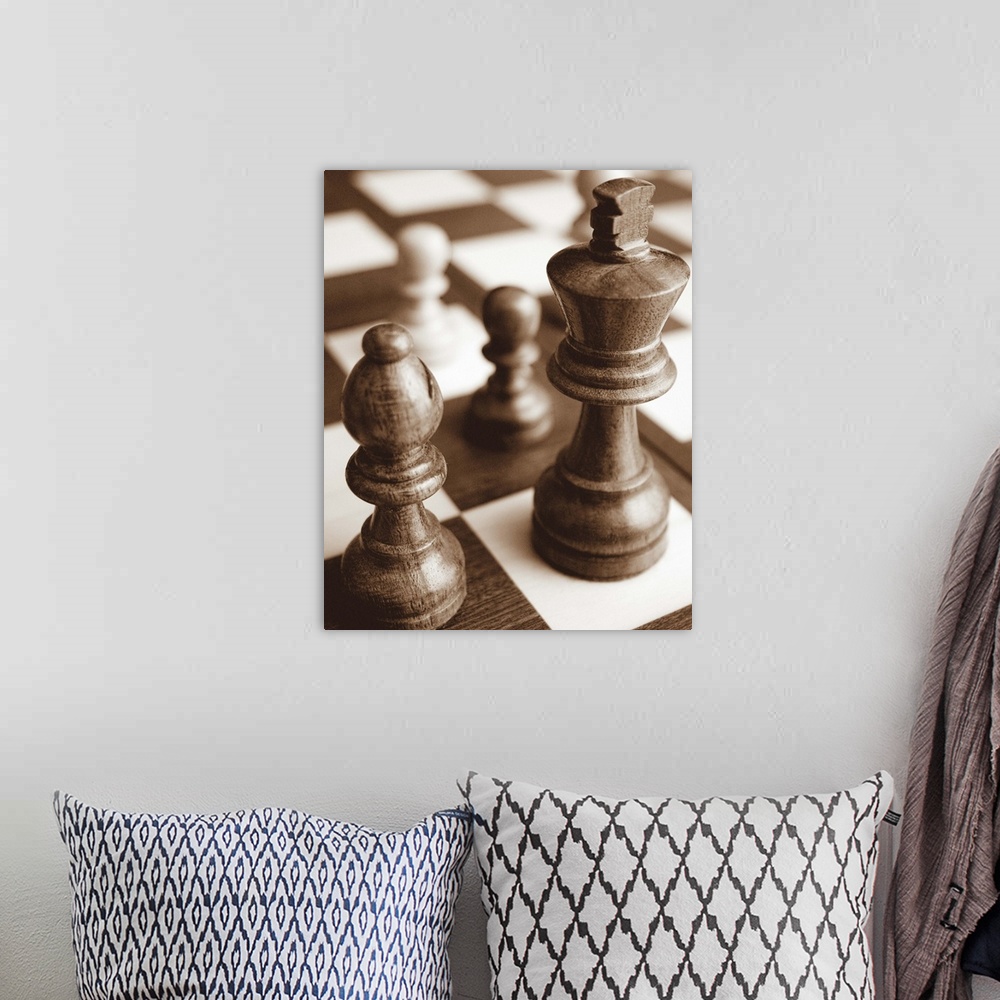 A bohemian room featuring Sepia toned photo of chess pieces on a game board.