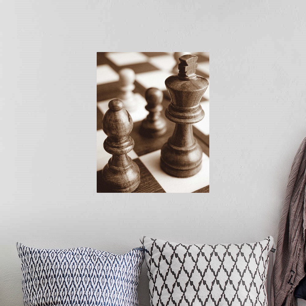 A bohemian room featuring Sepia toned photo of chess pieces on a game board.
