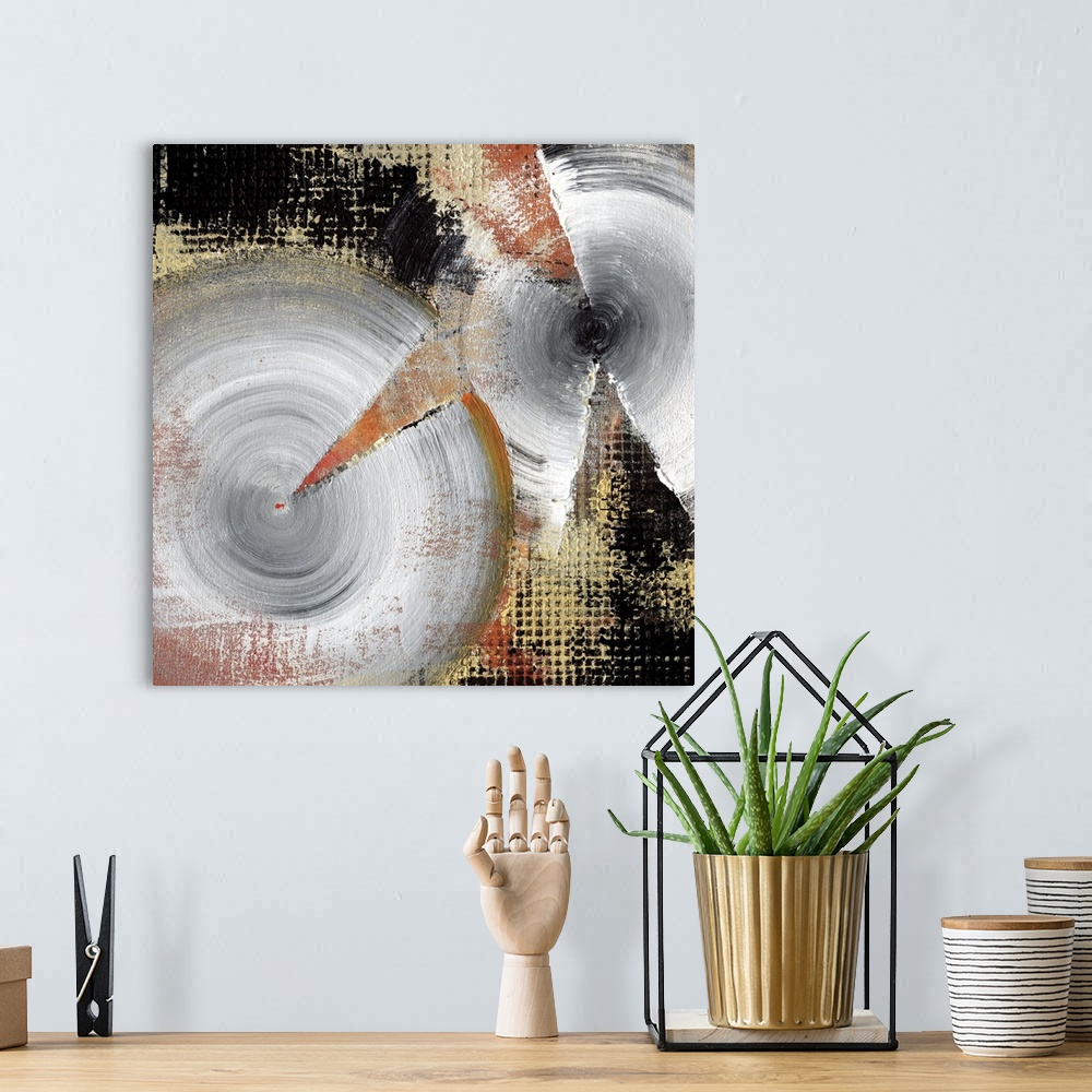 A bohemian room featuring A square abstract of silver spirals with textured gold and black backdrop.