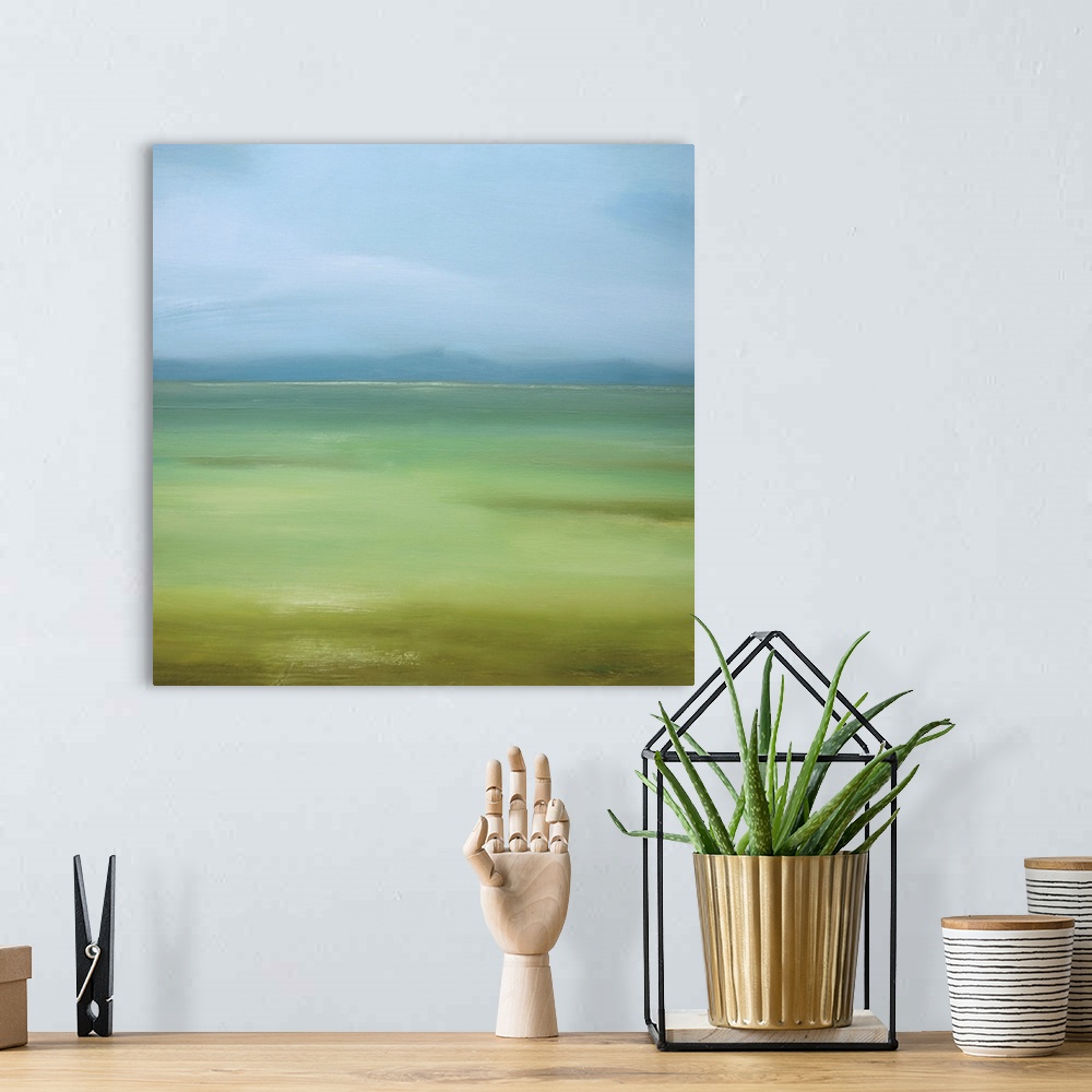 A bohemian room featuring Square painting of a landscape of green grass and blue skies.