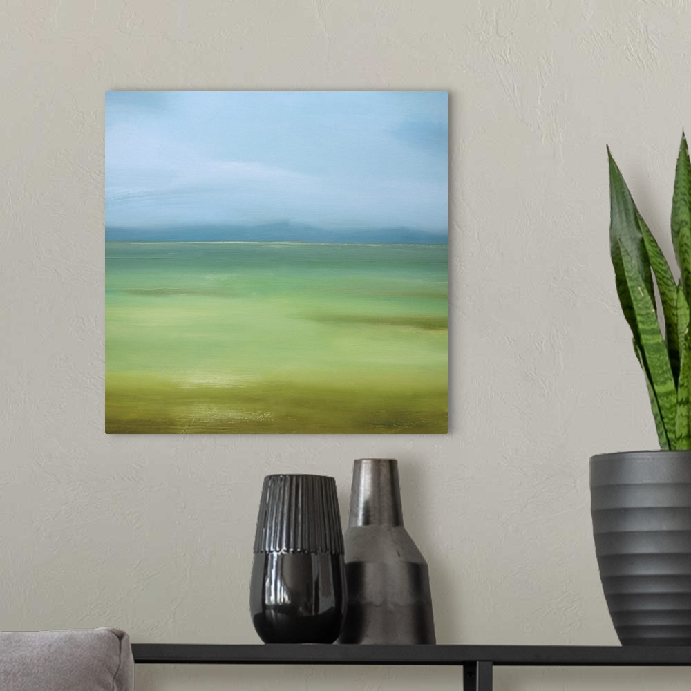 A modern room featuring Square painting of a landscape of green grass and blue skies.