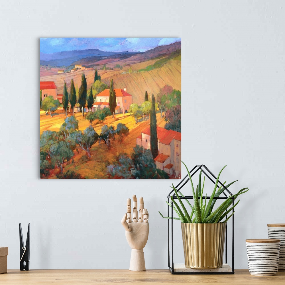 A bohemian room featuring A contemporary painting of a Tuscany countryside, with rolling hills and houses.