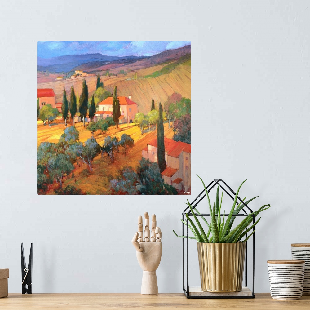 A bohemian room featuring A contemporary painting of a Tuscany countryside, with rolling hills and houses.