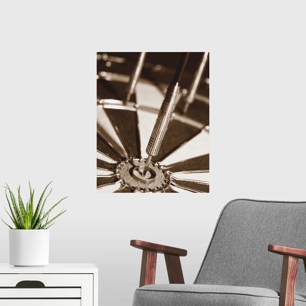 A modern room featuring Sepia toned photo of a dart in the center of a dart board.
