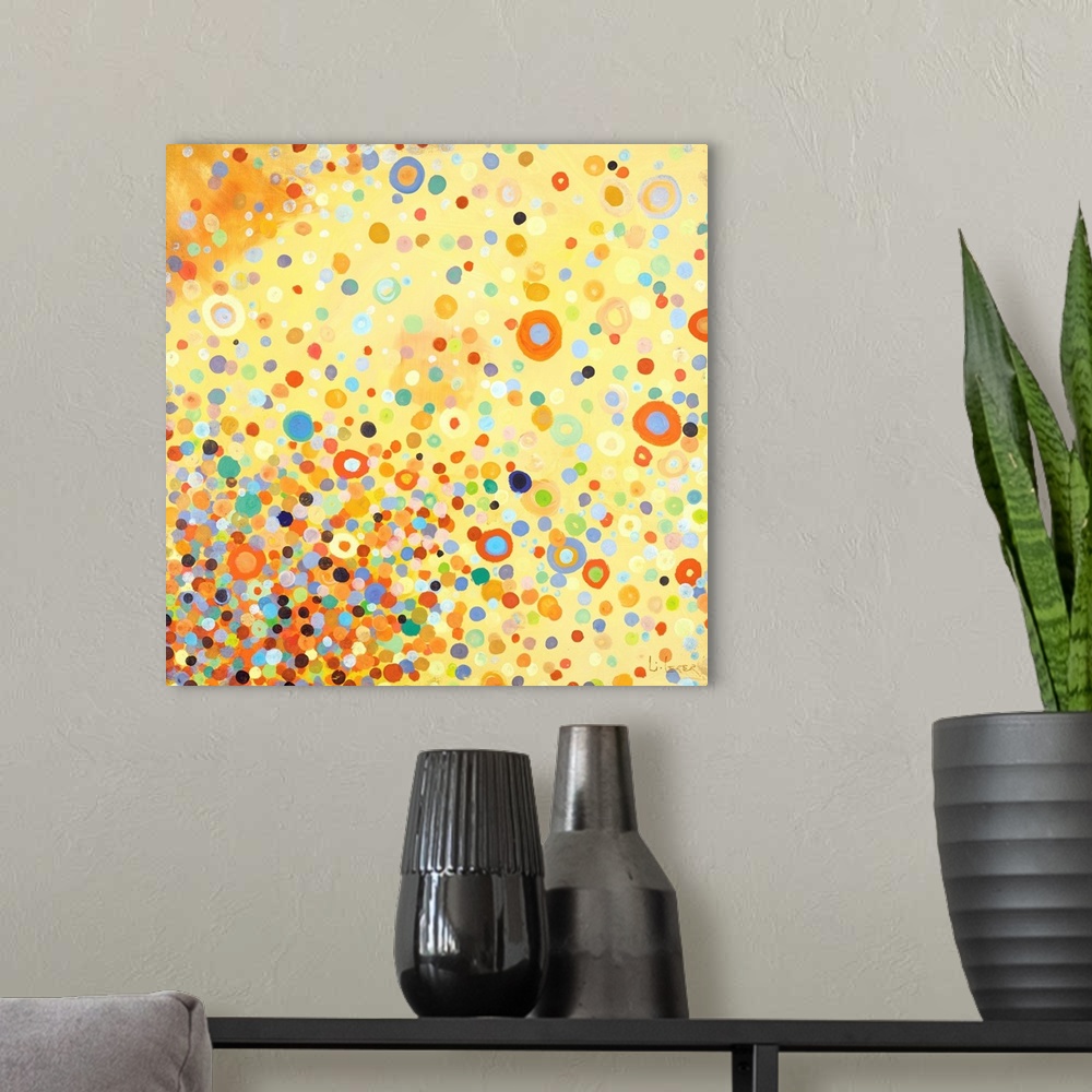 A modern room featuring Square contemporary painting of multi-colored circles in bright colors with a yellow background.