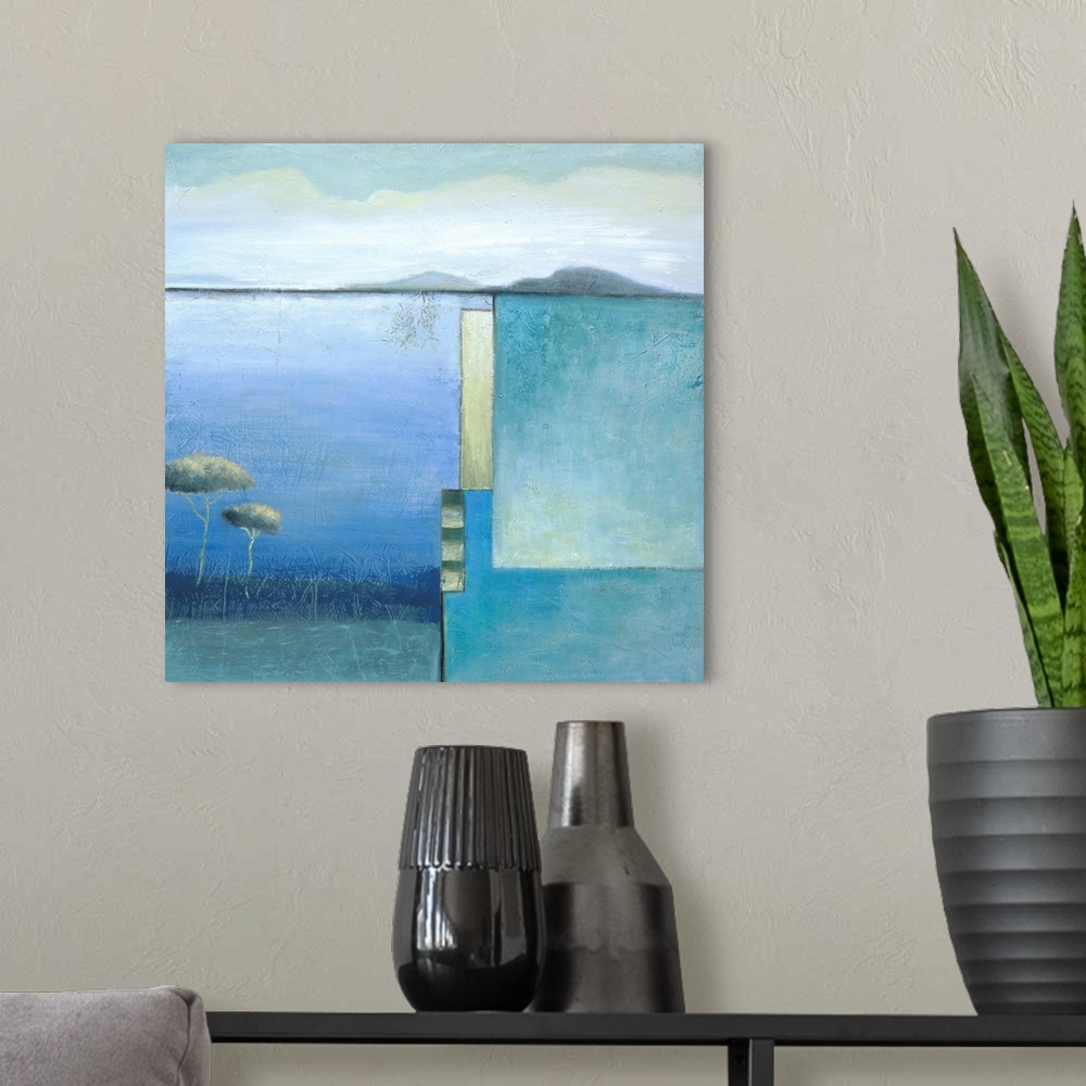A modern room featuring A square modern painting of a lake and mountain landscape with a square design on the right side.
