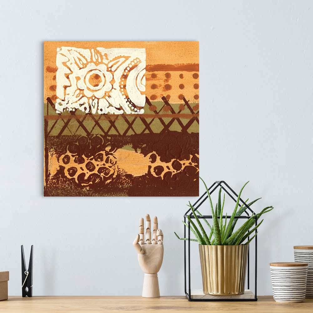 A bohemian room featuring Square abstract painting in earth tone colors of textured paint with one row of x's and another o...