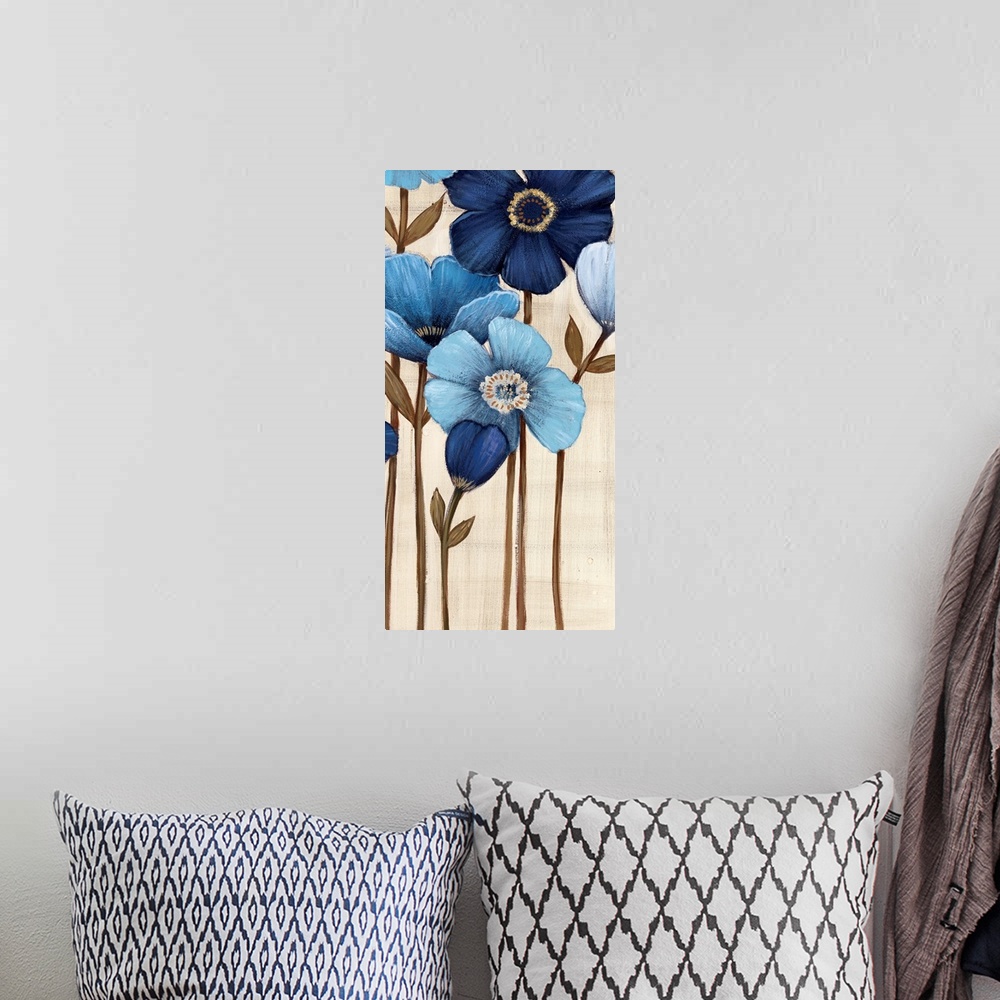 A bohemian room featuring Vertical painting of a group of blue flowers against a neutral backdrop.