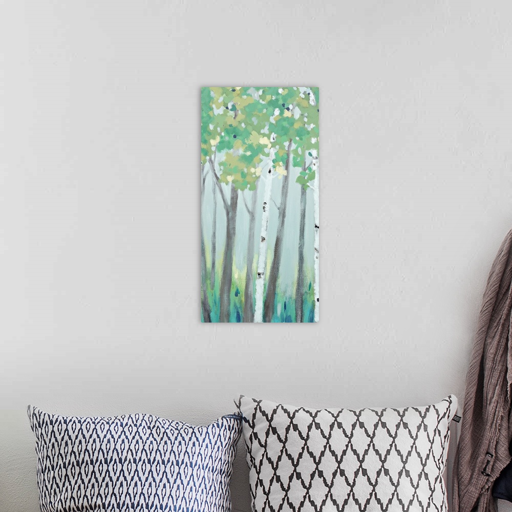 A bohemian room featuring A long vertical painting of a row of trees in muted cool tones.