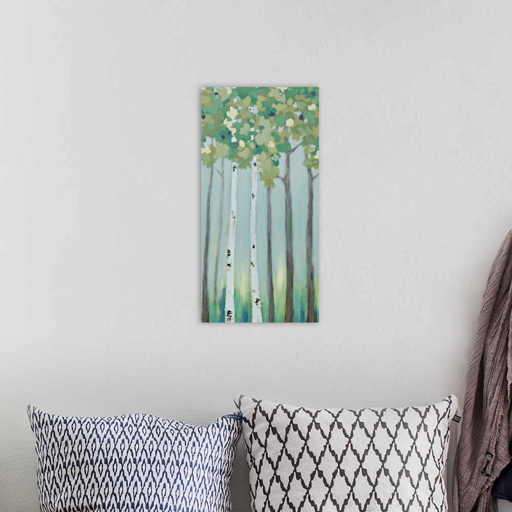 A bohemian room featuring A long vertical painting of a row of trees in muted cool tones.