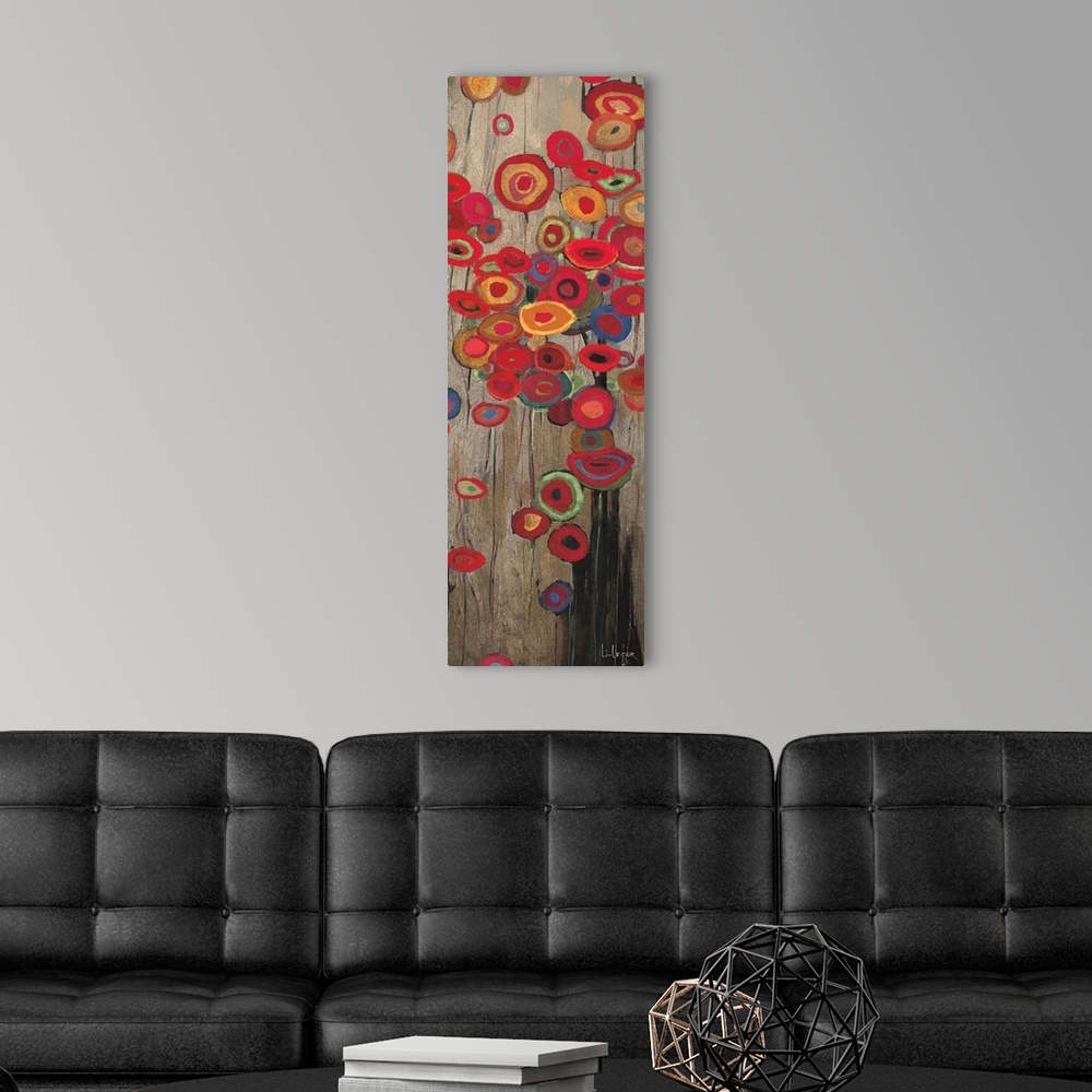 A modern room featuring A long vertical painting of a group of multi-colored poppies on a neutral backdrop.