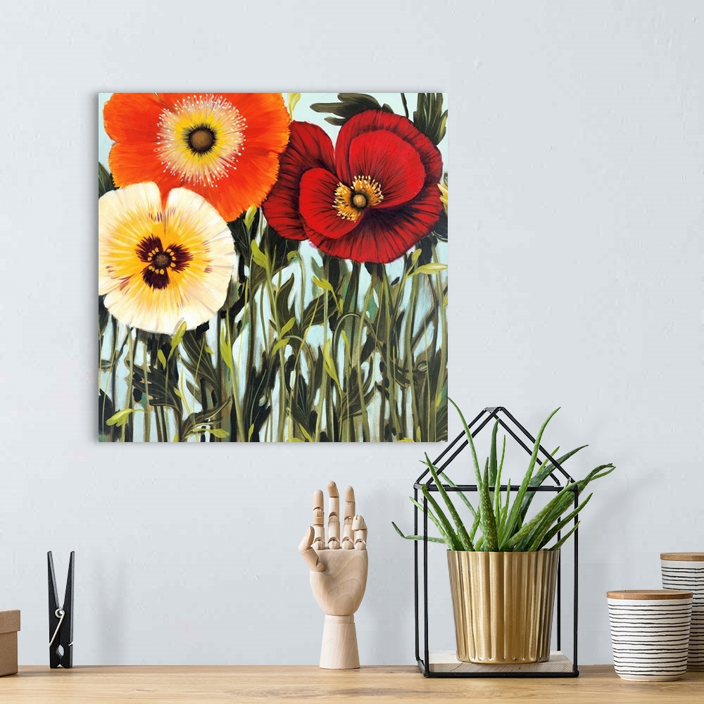 A bohemian room featuring Square painting of a group of multiple colored flowers in a garden against a blue backdrop.