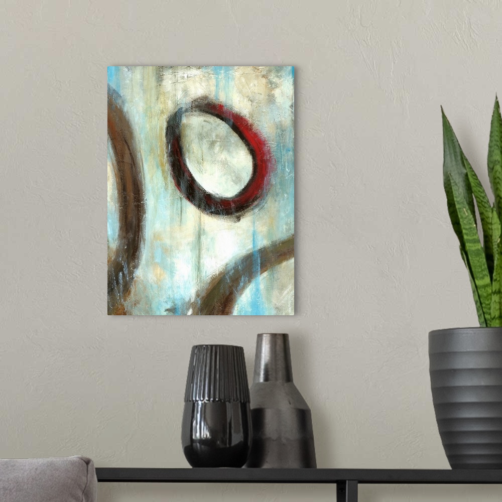 A modern room featuring Vertical painting of muted textured colors with circular rings overlapping.