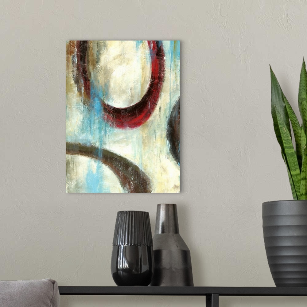 A modern room featuring Vertical painting of muted textured colors with circular rings overlapping.