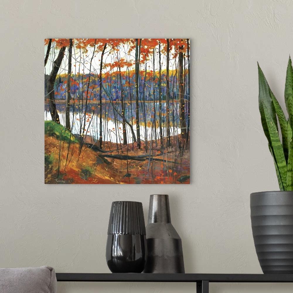 A modern room featuring A colorful fall scene of a forest surrounding a lake with the trees reflecting in the water.