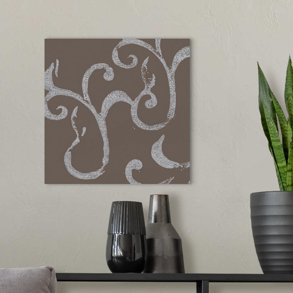 A modern room featuring A square abstract of flourish swirls in silver against of gray backdrop.