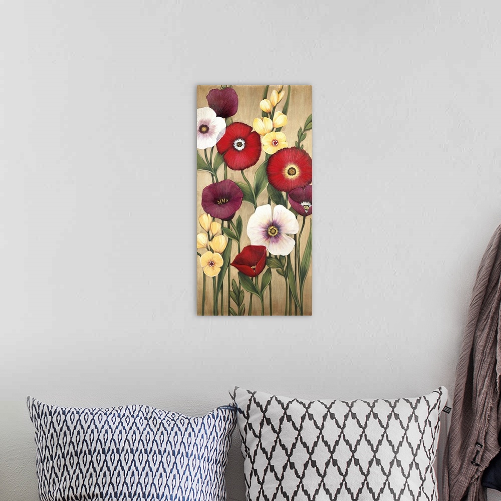 A bohemian room featuring Vertical painting of a group of red, pink and yellow flowers against a neutral backdrop.
