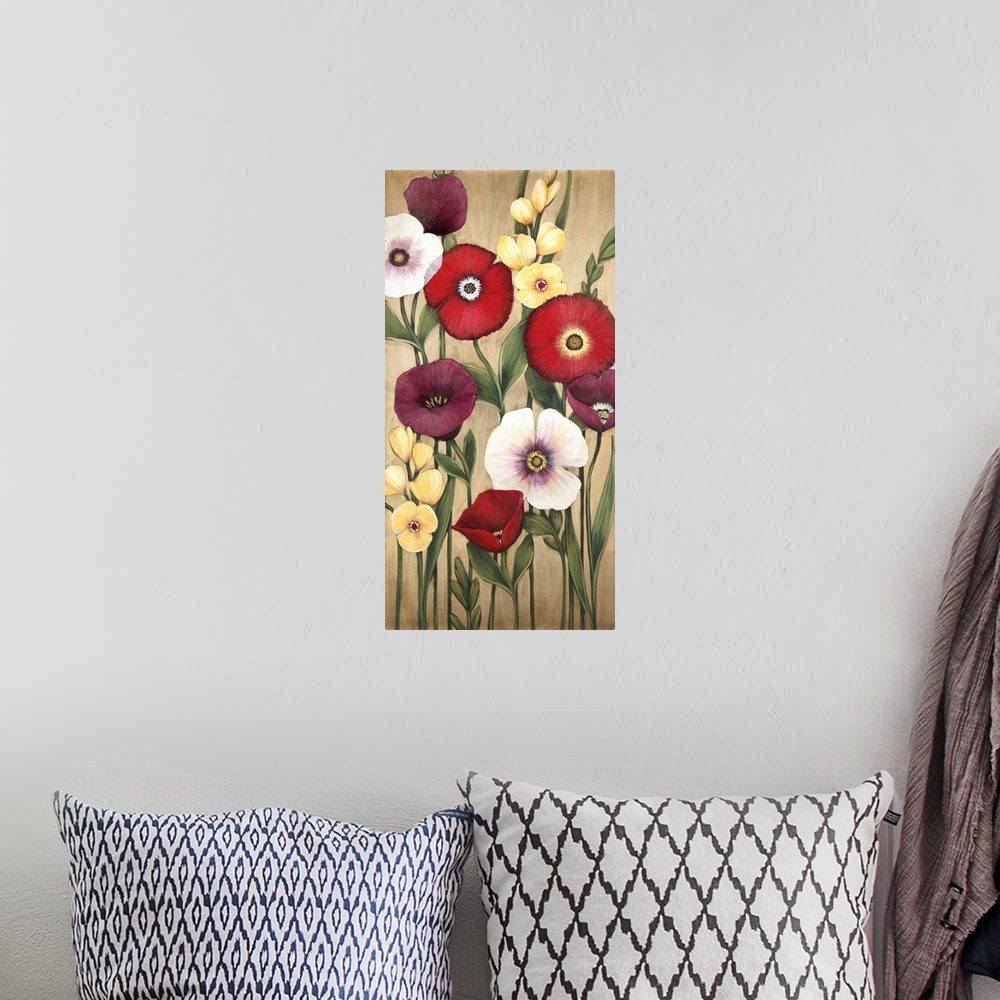 A bohemian room featuring Vertical painting of a group of red, pink and yellow flowers against a neutral backdrop.
