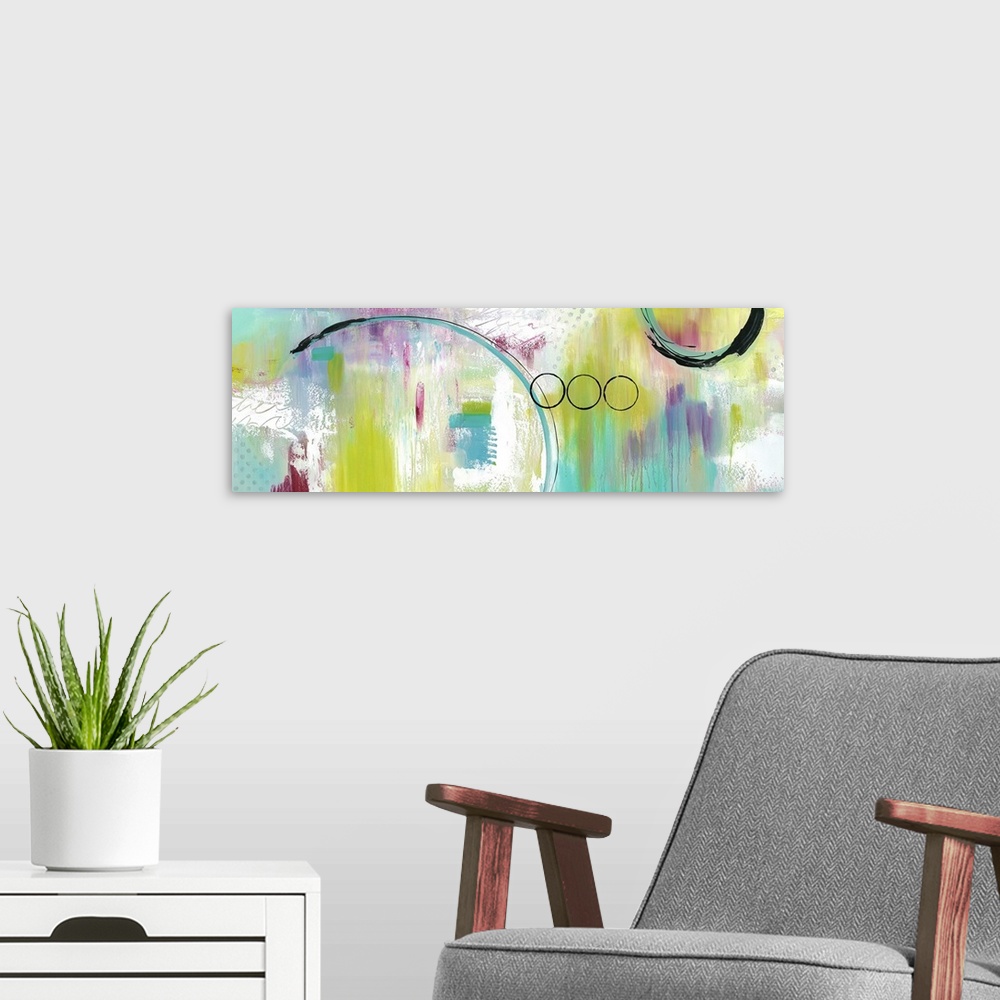A modern room featuring A long abstract painting of bright textured colors with circular elements overlapping.