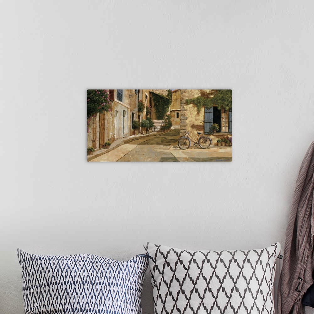A bohemian room featuring Painting of a bicycle outside a store in a European village.