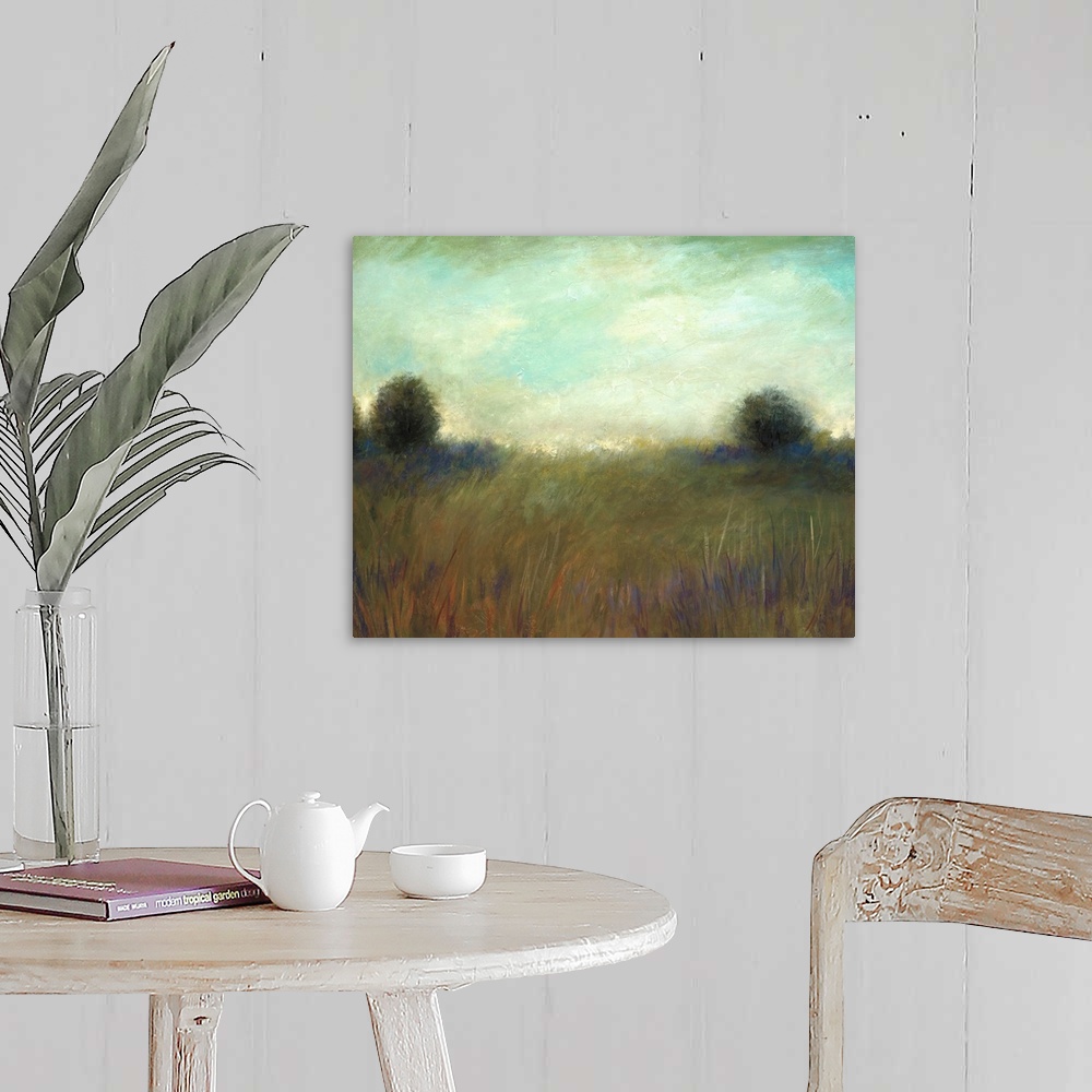 A farmhouse room featuring A muted contemporary painting of tall grass in a field with a line of trees in the background.