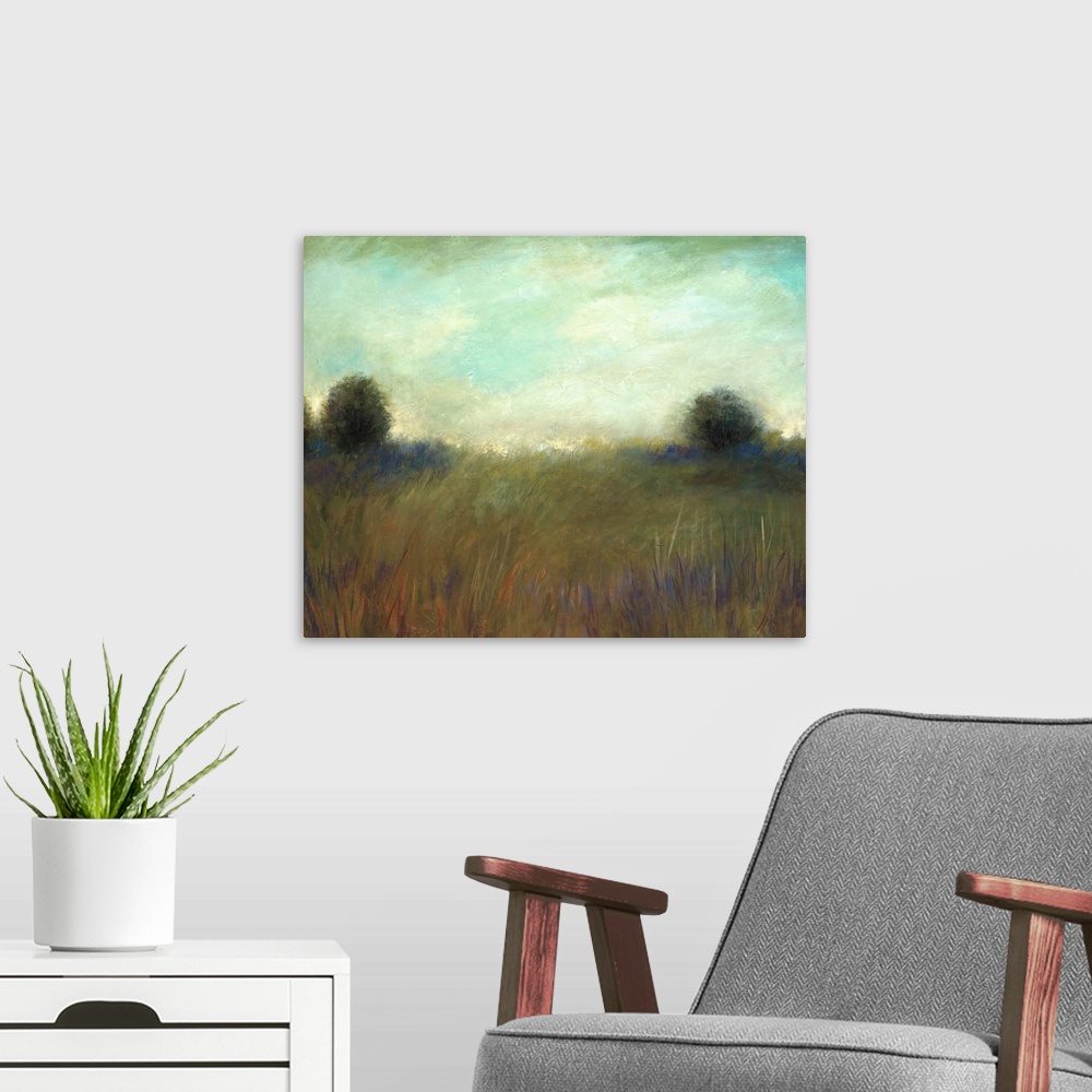 A modern room featuring A muted contemporary painting of tall grass in a field with a line of trees in the background.