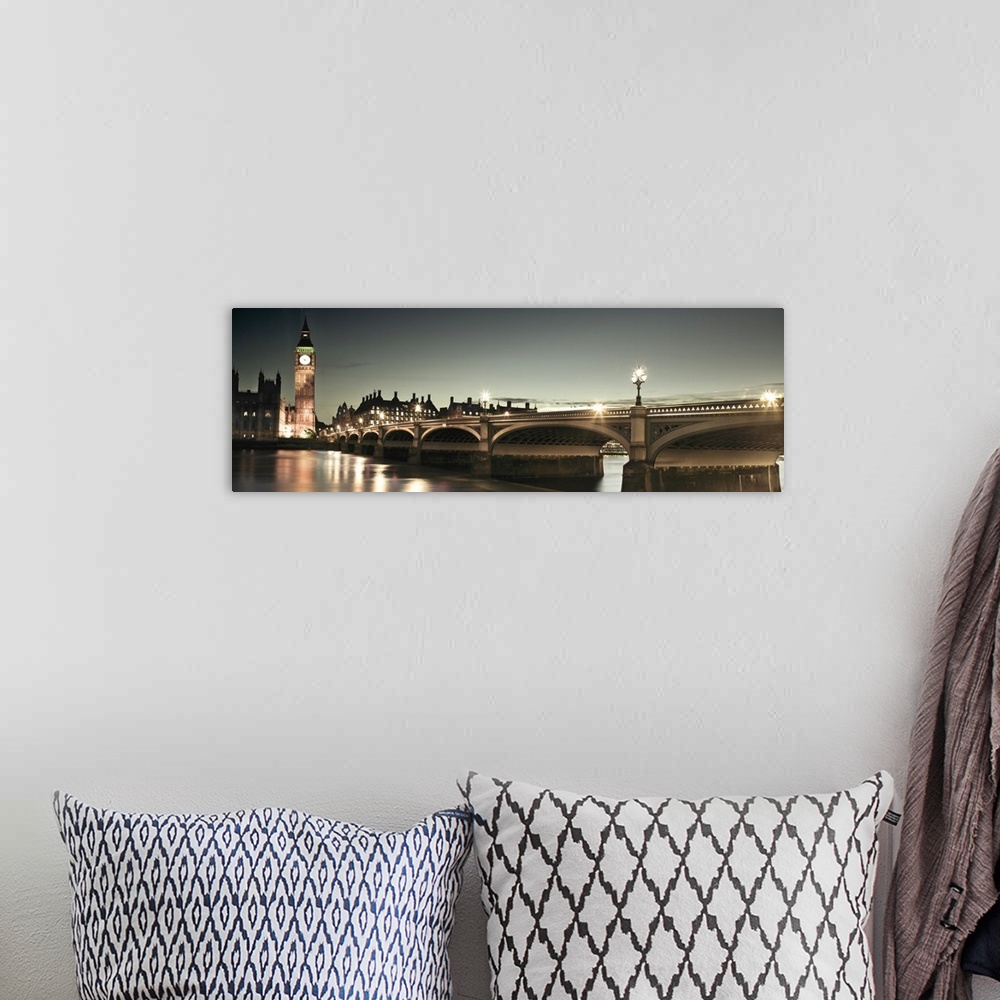 A bohemian room featuring A panoramic photograph of the Westminster Bridge next to Big Ben in London, England at night.