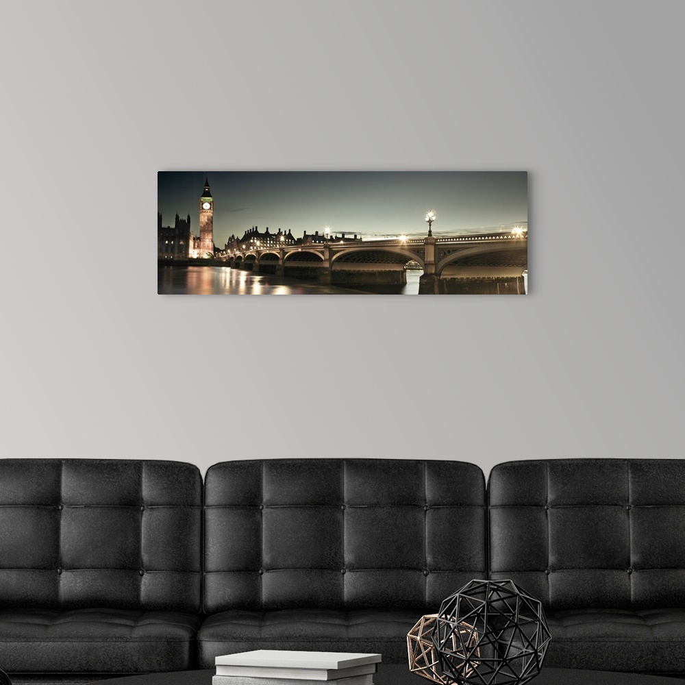 A modern room featuring A panoramic photograph of the Westminster Bridge next to Big Ben in London, England at night.