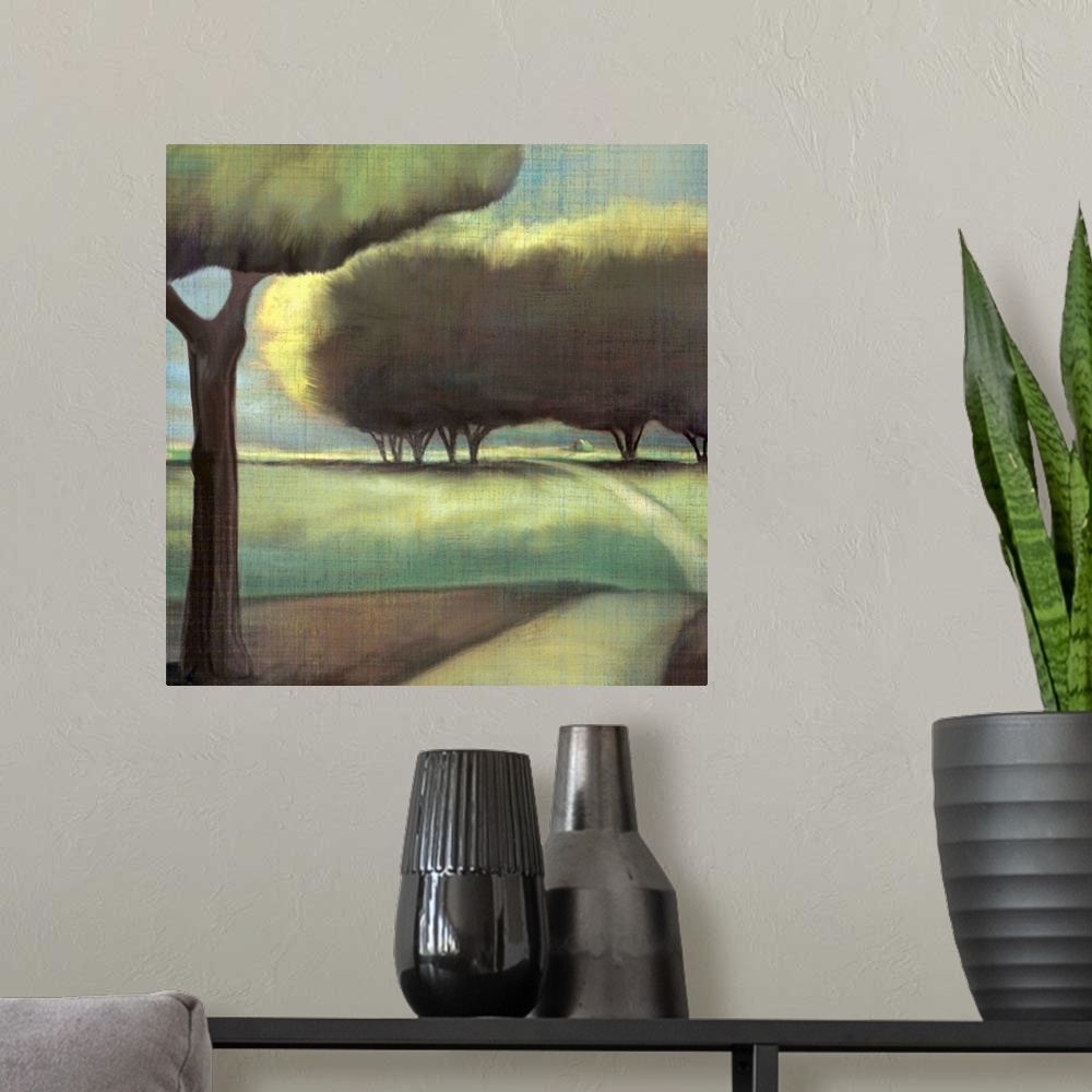 A modern room featuring Contemporary artwork of large trees in a hilly landscape with a narrow road.