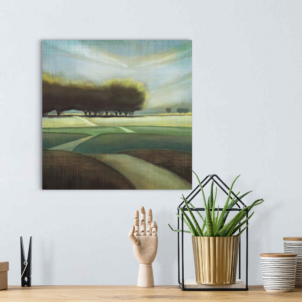 A bohemian room featuring Contemporary artwork of large trees in a hilly landscape with a narrow road.