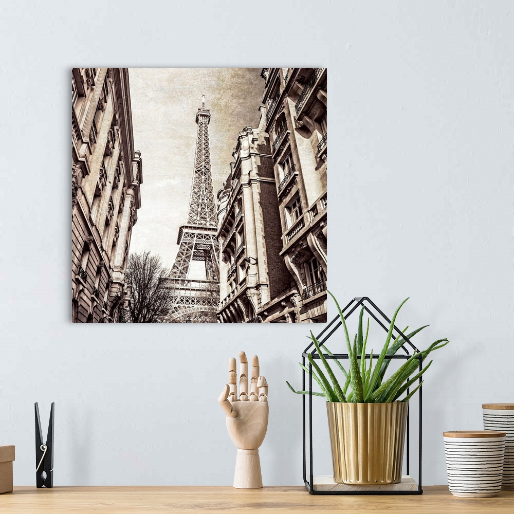 A bohemian room featuring A square photo of the Eiffel Tower from the street in a sepia tone and a textured effect overlay.