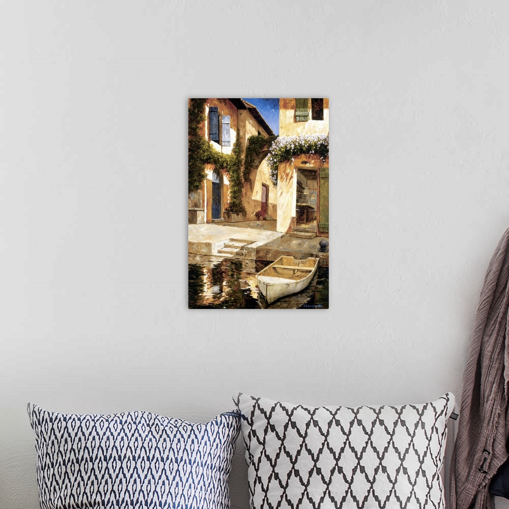A bohemian room featuring Painting of a boat docked near stairs in a European village.