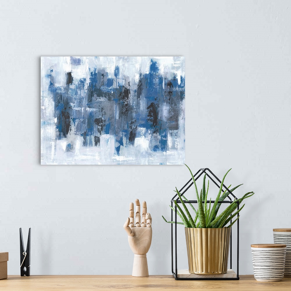 A bohemian room featuring Abstract painting in textured colors of blue, black, white and gray.