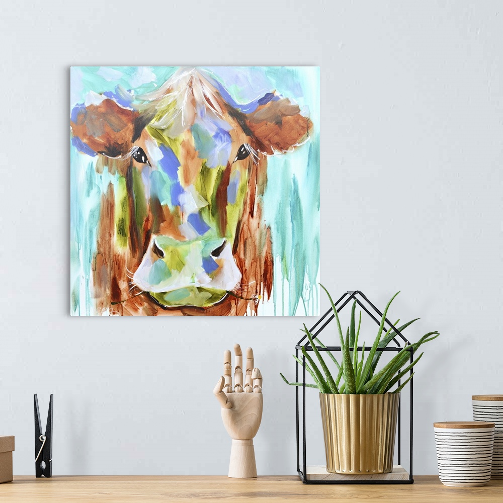 A bohemian room featuring A contemporary square painting of the face of a cow done in multiple colors with strokes of blue ...