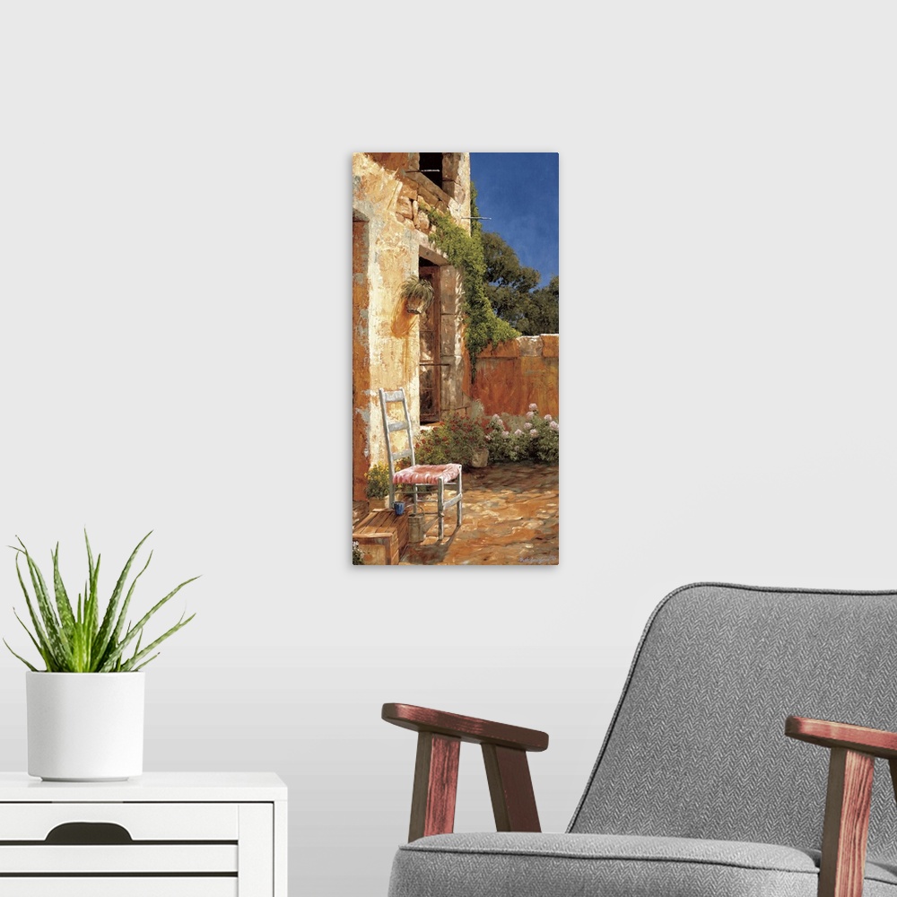 A modern room featuring Artwork of a chair outside a home in a European village.