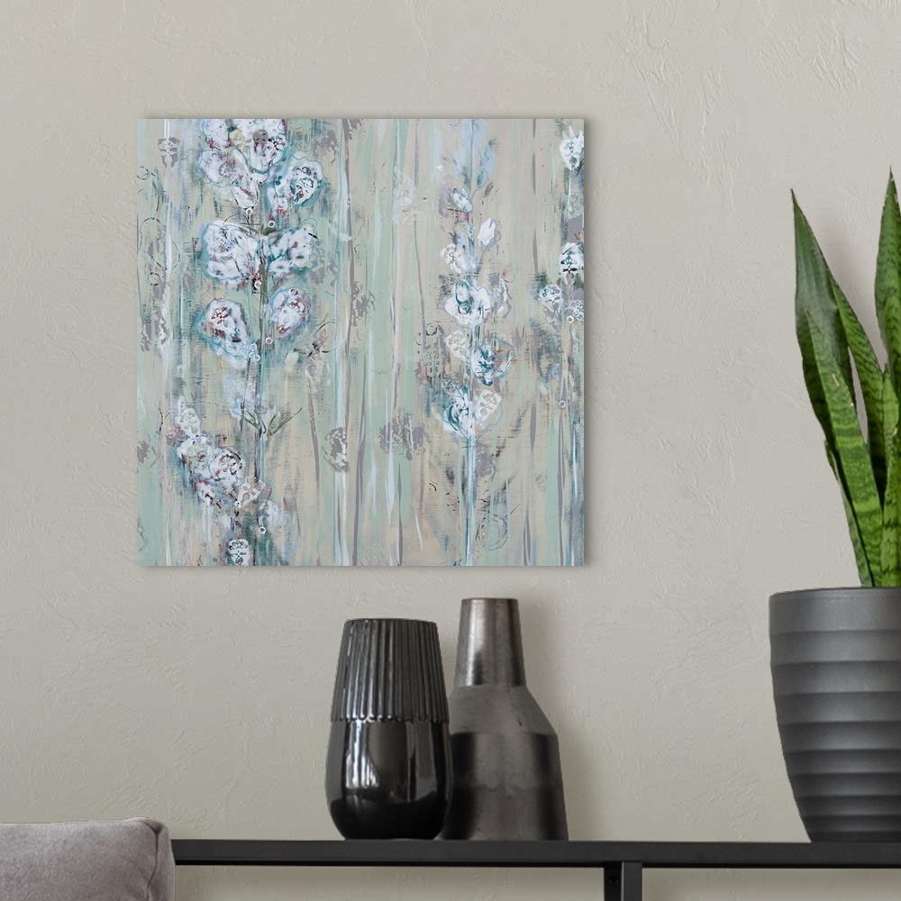 A modern room featuring Square contemporary floral painting in muted colors of gray, white and blue.