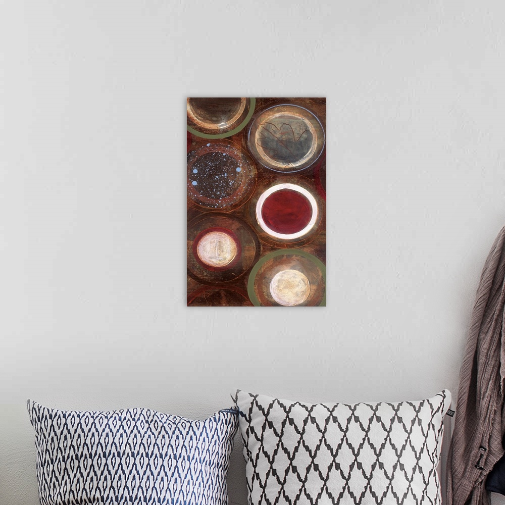 A bohemian room featuring Vertical modern painting of circles in multiple colors with speckles of blue paint overlapping.